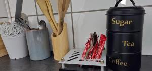 a table with utensils on a shelf with a container at Boabab at Greenway Woods in White River