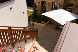 an umbrella sitting on a balcony with a patio at Kálvária panzió in Tata