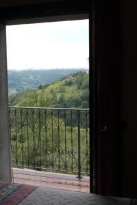 a room with a window with a view of a mountain at Baita del bosco in Laino