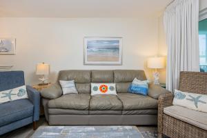 a living room with a couch and a chair at Harbor House B19 condo in Gulf Shores