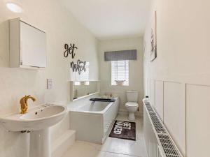 a white bathroom with a sink and a toilet at 3 Bed in Hamsterley 89896 in Witton le Wear +23 photos