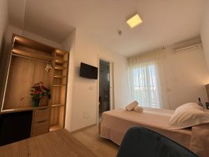 a bedroom with a bed and a television in it at Hotel Berna in Eraclea Mare