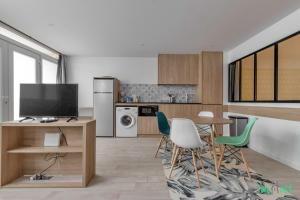 a kitchen with a table and chairs and a television at Louis Vicat 6 - CI - Ideal apartment for 4 Paris Expo Porte de Versailles in Paris +4 photos