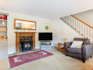 a living room with a couch and a tv and a fireplace at 3 Bed in Saint Austell 95623 in Gorran Haven