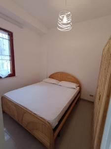 a bed in a bedroom with a light above it at Case Vacanze Rodi Garganico in Rodi Garganico