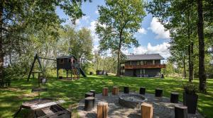 a backyard with a playground and a house at Brīvdienu māja Sniegi in Madona