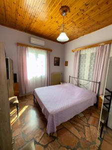 a bedroom with a bed and a wooden ceiling at Nidi House in Nafpaktos