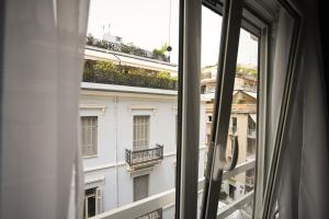 an open window with a view of a building at Syntagma Plaka Suite by Zeussuites in Athens