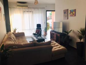 a living room with a couch and a tv at Apartment Michail in Skála Nikíta