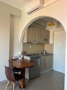 a kitchen with a table and a sink and a stove at Christina Sea View in Ágios Konstantínos