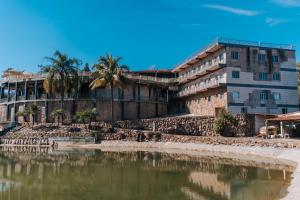 カブレウーヴァにあるHotel Pousada Villa Itália - Cabreúvaの海水の横の建物