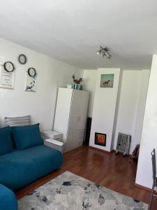 a living room with a blue couch and a fireplace at Apartament Craiova in Craiova