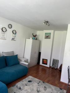 a living room with a blue couch and a white cabinet at Apartament Craiova in Craiova