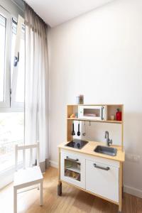 a kitchen with a sink and a microwave at Amazing, Sea Views & Terrace in Santa Úrsula