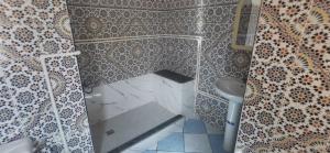 a bathroom with a shower with a toilet and a sink at Hotel Complex Europe in Guercif