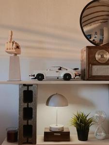 a toy car sitting on a shelf next to a lamp at Ikigai Penthouse Apartment in Banja Luka