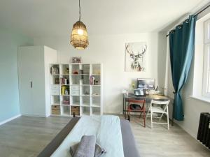 a bedroom with a bed and a desk and a table at 67-Ratusz - DeerRest Apart in Jelenia Góra