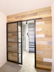 a room with a wooden wall and a closet at 67-Ratusz - DeerRest Apart in Jelenia Góra