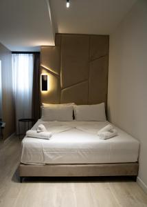 Postel nebo postele na pokoji v ubytování Hotel Mefolinkel Suits