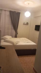 Postel nebo postele na pokoji v ubytování Areti Rooms Hotel