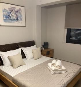 a bedroom with a large bed with towels on it at Villa Modern Nikiti in Nikiti +23 photos