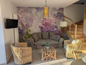 a living room with a couch and a flower mural at Domaine de Kerhallec in Treffléan