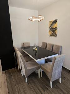 a dining room with a black table and chairs at Apartments Villa Joja in Međugorje