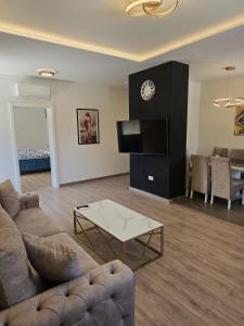 a living room with a couch and a tv and a table at Apartments Villa Joja in Međugorje