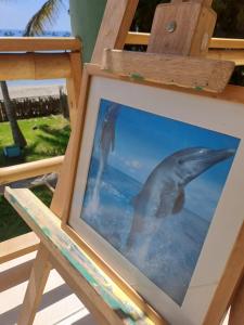 a picture of two dolphins in the water at H0TELIER Home, Máncora in Máncora