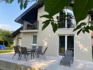 a patio with chairs and a table in front of a house at Hacienda DM in Visoko
