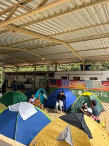 un gruppo di persone in tende in una stanza di Camping Shangrilá São Thomé a São Thomé das Letras Altre 8 foto