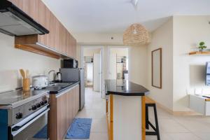 a kitchen with a counter top and a stove at 2-Bedroom Retreat in Avida Riala Prime Location in Cebu City +18 photos