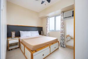 a bedroom with a bed and a window at 2-Bedroom Retreat in Avida Riala Prime Location in Cebu City