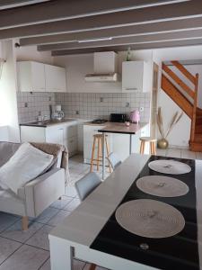 una cucina con un tavolo e sedie in una stanza di location vacance a Gommenecʼh
