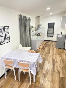 a kitchen and dining room with a table and chairs at Teratak Orked in Pekan +11 photos