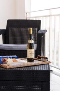 a bottle of wine sitting on top of a table at Sunset Beach Apartment in Vila Praia de Âncora