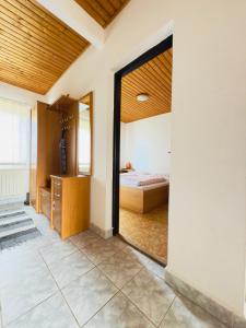 a bedroom with a bed and a large doorway at Apartmán Penziónu Hrubjak in Oravská Polhora