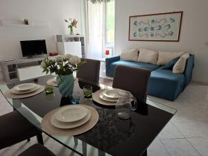 a living room with a table and a blue couch at Raffa al Pigneto in Rome +10 photos