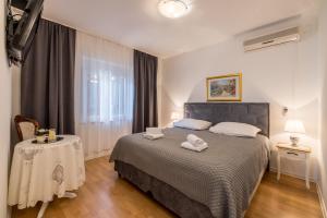 Ένα ή περισσότερα κρεβάτια σε δωμάτιο στο Guesthouse Rooms Split