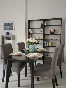 a dining room with a black table and chairs at Raffa al Pigneto in Rome +10 photos