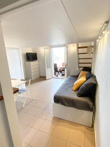 a bedroom with a bed and a living room at Studio front de mer Valras-Plage 2-4 personnes in Valras-Plage