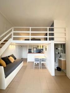 a living room with a couch and a loft bed at Studio front de mer Valras-Plage 2-4 personnes in Valras-Plage