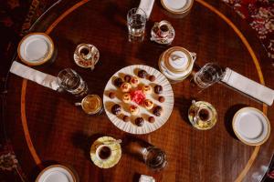 a wooden table with a plate of pastries on it at Castello di Casalborgone, Luxury Italian Castle Hotel in Casalborgone