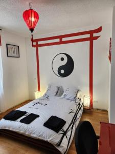 a bedroom with a large bed with a black and white comforter at Maison Fatonnette in Vendôme +22 photos