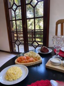 a table with plates of food on top of it at Villaggio Farnese in Campos do Jordão +40 photos