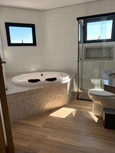 Un baño con bañera y WC. en Hotel Acanto, en Rio Verde