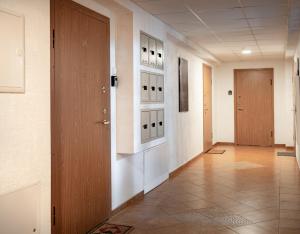 a hallway with two doors and a tile floor at Cozy Mill apartment in Palanga
