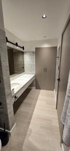 ein Badezimmer mit Waschbecken und großem Spiegel in der Unterkunft La Residence Panamá in Panama-Stadt