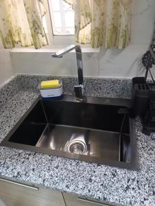 a stainless steel sink in a tiny kitchen at Comfort, safety and close to everything in Los Paredones +28 photos