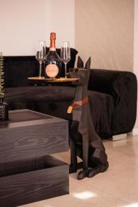 a table with two glasses and a bottle of wine at MM Modern in Alba Iulia